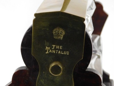 A 19thC Betjemann's Patent walnut and brass Tantalus, with four square section decanters and stoppers label to front Tiffany and Co, 35cm wide. - 3