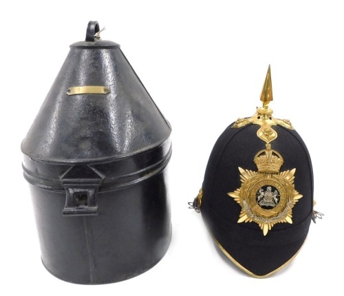 A Victorian Manchester regimental helmet, with a gilt metal spike, in tin travelling case, with vacant plaque.