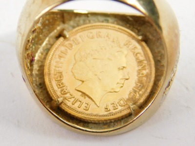 A Queen Elizabeth II St George half gold sovereign ring, the sovereign dated 2005 with warrior on horseback, in a 9ct gold ring mount, set with diamonds to rim and diamonds and rubies to shoulders, formed as the England flag, ring size X½, 10g all in. - 2