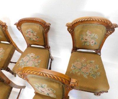 A set of fourteen Victorian elm and burr elm dining chairs, each with an arched gadrooned back with moulded leaf carved supports, with a wool work padded back and seat, on turned tapering fluted legs, with H stretcher and ceramic castors. - 6