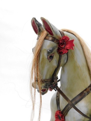 A dapple grey painted rocking horse, with leather saddle and bridle, etc., on an ash trestle base with turned supports, 128cm high, 150cm long. - 2