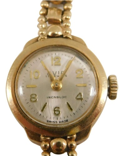 An Avia 9ct gold ladies wristwatch, the small silvered dial 1.5cm diameter, on a fancy link bracelet, stamped 375, 12.9g all in.