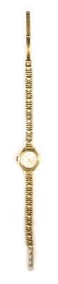 An Avia 9ct gold ladies wristwatch, the small silvered dial 1.5cm diameter, on a fancy link bracelet, stamped 375, 12.9g all in. - 2