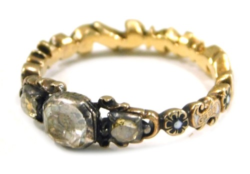 A Victorian memorial dress ring, set with three foil backed old cut imitation diamonds, with enamel work band, with white and black flowers, yellow metal unmarked, ring size O, 4.4g all in.