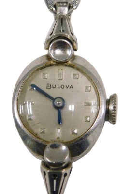 A Bulova stainless steel cased ladies wristwatch, the oval watch head, with a silvered dial and blue hands, 1cm diameter, on stainless steel bracelet.