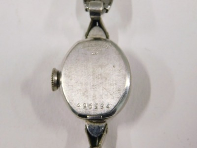 A Bulova stainless steel cased ladies wristwatch, the oval watch head, with a silvered dial and blue hands, 1cm diameter, on stainless steel bracelet. - 3