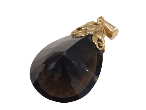 A smokey quartz pendant, the tear drop cut smokey quartz, 4cm high x 2.5cm wide, with a 9ct gold floral twist top, the pendant 6cm high, 20.5g all in.