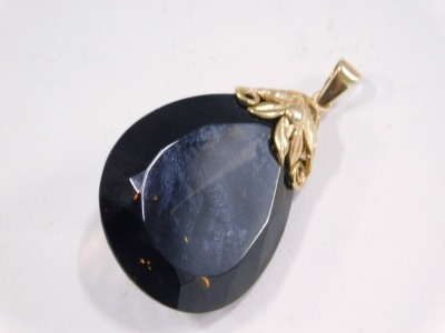 A smokey quartz pendant, the tear drop cut smokey quartz, 4cm high x 2.5cm wide, with a 9ct gold floral twist top, the pendant 6cm high, 20.5g all in. - 2