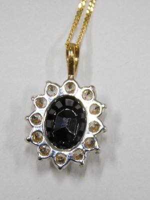 A pendant and chain, the floral cluster pendant set with imitation sapphire and diamond, 2cm high, on a fine link neck chain, yellow metal stamped 375, 42cm long, 2.2g all in, boxed. - 4