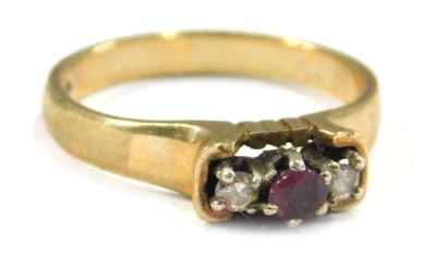 A 9ct gold three stone dress ring, set with garnet and diamonds, each in raised claw setting, on a plain band, ring size M, 2.4g all in.