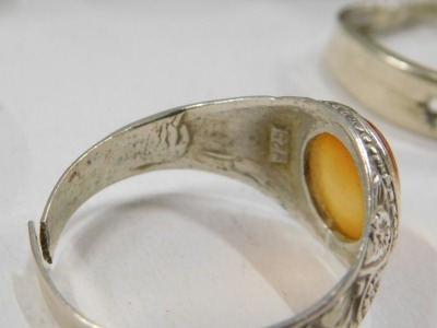 A group of white metal dress rings, to include some stone set with imitation amber, tigers eye, and others, some cut, mainly stamped 925 or 935, 49.6g all in. (9) - 2