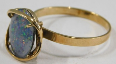 An imitation opal dress ring, the imitation opal doublet, with dark blue flare, in a raised yellow metal coloured mount, on yellow metal coloured band, believed to be gold plated, ring size W½. - 2