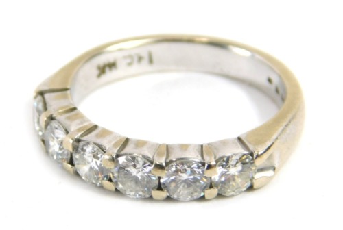 A diamond half hoop dress ring, set with six round brilliant cut diamonds, measuring between 3.35mm and 3.4mm diameter, estimated total ct weight 0.90ct, claw set on a white gold band, with rubbed markings, stamped 14k, assessed clarity SI/I1, assessed co