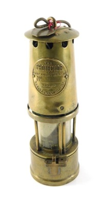 A Protector brass miner's lamp, 28cm high.