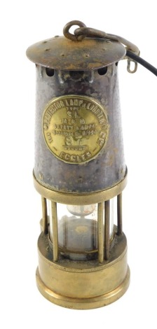 A Protector Lamp and Lighting Company mining lamp, numbered 87, bearing crest in carry hook, converted to electricity, 23cm high.