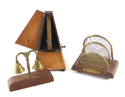 A French Maelzel metronome, in walnut case, a small brass letter rack, and a pair of horse bells. (3)