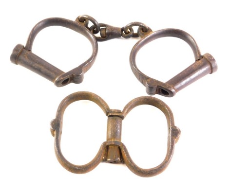 A pair of Hiatt late 19thC police handcuffs, numbered 231, and another pair of handcuffs. (2)