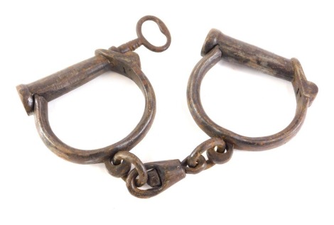 A pair of J Froggatt Victorian police handcuffs, with key.