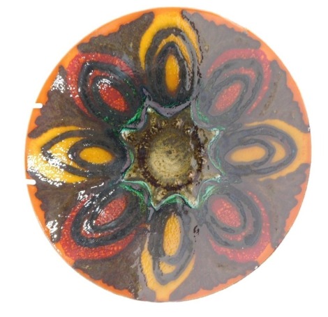 A Poole Delphis charger, decorated with ovals in shades of orange, green, yellow, etc., 27cm diameter.