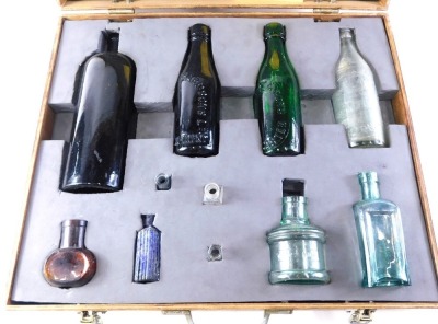 A collection of 19thC and later glass bottles, to include Lions Ink, Stoke On Trent bottles, Doncaster, and others, in ply case.