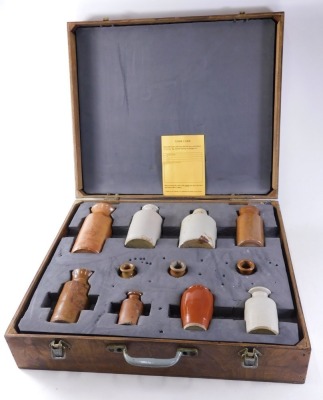 A collection of 19thC and later stoneware bottles, each brown or cream treacle glazed, in fitted ply case, the largest 17cm high. - 2