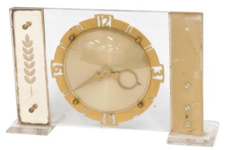 A 1960s mantel clock, with Perspex rectangular moulding, with a cold painted circular dial, 16cm high, 25cm wide. (AF)