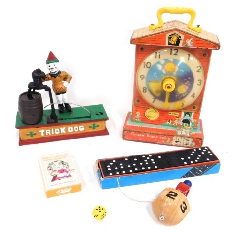 A novelty trick dog money box, 18cm high, 19cm wide, a Fisher Price music box teaching clock, cased set of dominoes, playing cards and other Fisher Price toys. (1 box)