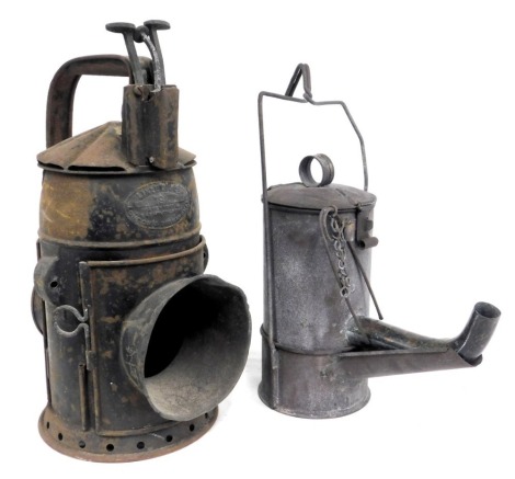 A railway hand lamp, GWR pattern, 33cm high, and a road worker's oil lamp, circa 1915, 32cm high. (2)