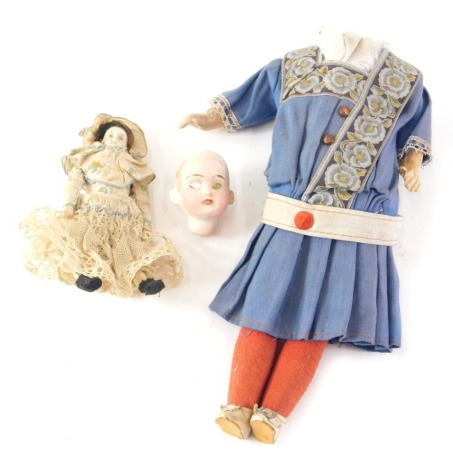 A 19thC bisque headed doll, with shut eyes and open mouth, on a composite body in original dress, circa 1895, the head stamped Germany, and an additional 19thC porcelain headed miniature doll, 29cm and 12cm high. (2)