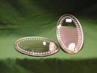 A pair of early 20th C oval Wall Mirrors with bevelled edges and bead borders