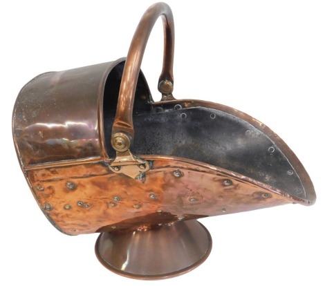 A Victorian copper helmet shaped coal scuttle, with swing handle.