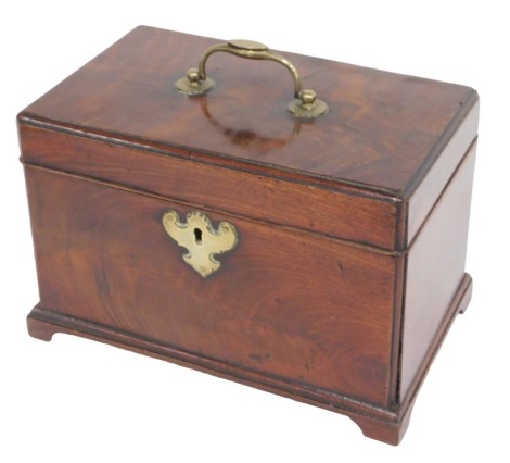 A George III mahogany tea caddy, the hinged top with a brass handle enclosing three divisions to the interior, on bracket feet, 23cm wide.