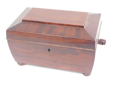 A Victorian mahogany sarcophagus shaped caddy, the hinged lid enclosing an interior with two smaller caddies flanking a mixing bowl, lacking handles, 28cm wide.