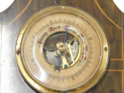 An Edwardian inlaid and stained wood aneroid barometer, with opaque glass thermometer, 49cm high. - 2