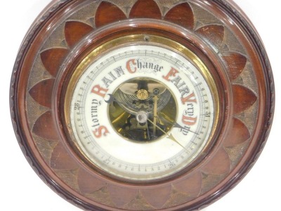 An early 20thC carved mahogany cased aneroid barometer, with opaque glass thermometer, 51cm high. - 2