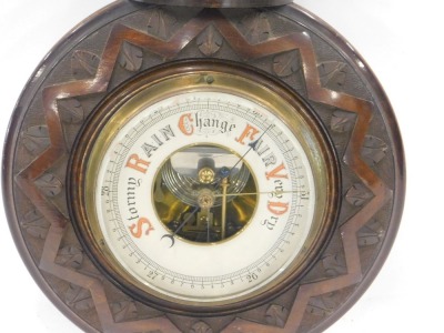 A late 19th/early 20thC carved mahogany aneroid barometer, 48cm high. - 2