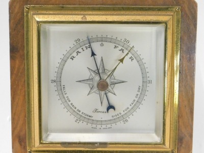 An Art Deco walnut and rosewood aneroid barometer with thermometer, 41cm high. - 2