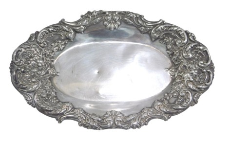 A Victorian silver pin dish, of oval form with embossed floral and scroll border, maker D&F, Birmingham 1899, 1.93oz, 17cm wide. (AF)