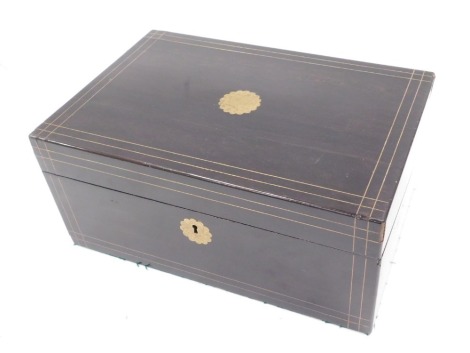 A Victorian ebonised and brass inlaid writing box, the hinged top with vacant flower head shaped cartouche enclosing a fitted interior with black and gilt leather insert, 35cm wide.