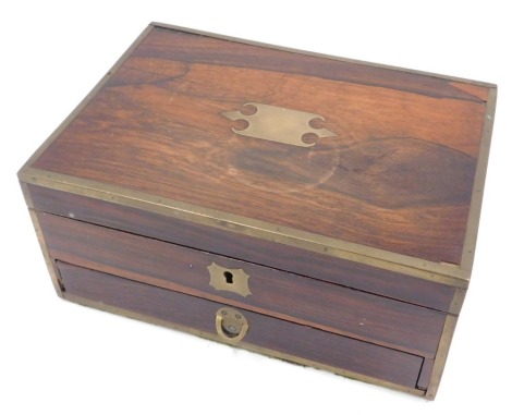 A Victorian rosewood and brass bound campaign style dressing table case, the top with a vacant brass cartouche enclosing a fitted interior with a mirror, velvet lined compartments and two bone jars and covers, 25.5cm wide. (AF)