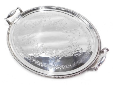 A John Edwards EPNS silver plated serving tray, with a beaded and embossed design with camphor leaf handles, 63cm wide.