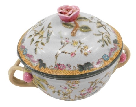 A late Oriental two handled jar and cover, decorated in European style with flowers, etc., 22cm wide.