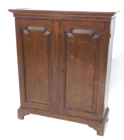 A George III oak side cabinet, two doors, each with arch panels on bracket feet, 84cm high, 79cm wide.