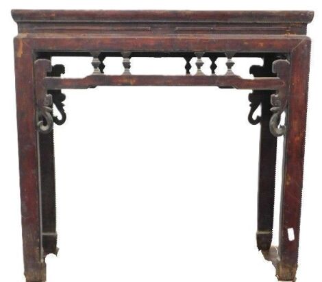 A Chinese red stained altar table, with a pierced frieze and shaped legs, 84cm high, 89cm wide.