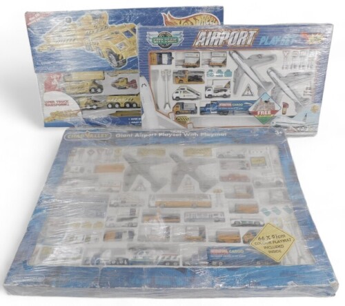 Hot Wheels by Mattel and Chad valley play sets, including Hot Wheels Mega Rig construction site, Chad Valley giant airport play set with play mat, and City Team Action Pack airport play set, boxed. (3)