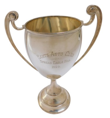 Motor Racing Interest. A George V silver two handled trophy awarded to Raymond Mays, the circular tapering bowl with scroll handles, on a circular stepped base for the Hants Auto Club Spread Eagle Hill 1924, London 1921, 20.21oz, 28cm high. Provenance: Be