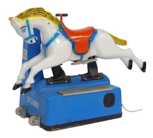 A Mitchell's RGM fairground horse ride, on a blue base with coin payment section, the plastic horse on a white ground with red saddle, manufactured by RG Mitchell Limited of Skegness, voltage 220/240V, model number 6, serial number AA3596, 97cm high, 121c