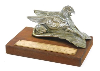 A Terraplane Griffin car mascot, used on both Hudsons and terraplanes, mounted on a rectangular wooden base, 13cm high, 18cm wide, 11cm deep.