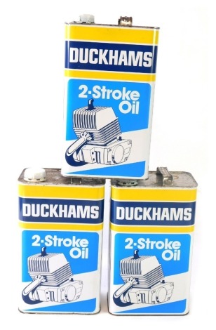 Three Duckham's Two Stroke vintage oil cans, partially filled. (3)