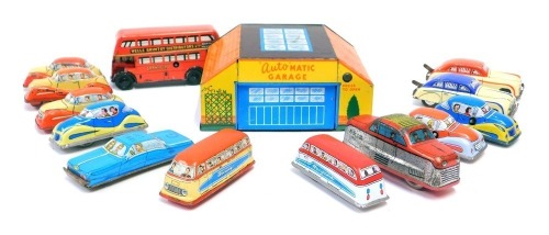 Tinplate models, comprising British made wind up cars, an automatic garage and a London red bus, no keys.